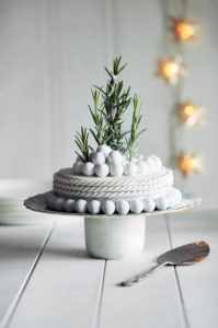 Close up of richly decorated Halloween cake with white icing and rosemary sprigs. Close up of richly decorated Halloween cake with white icing and rosemary sprigs.